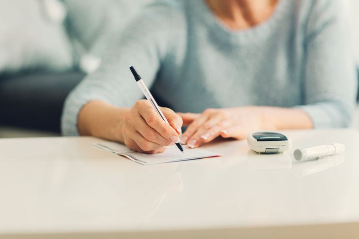 person-writing A study of type 2 diabetics found that a low-carb, low-sugar diet produced more stable levels of healthy blood sugar than a low-fat diet.