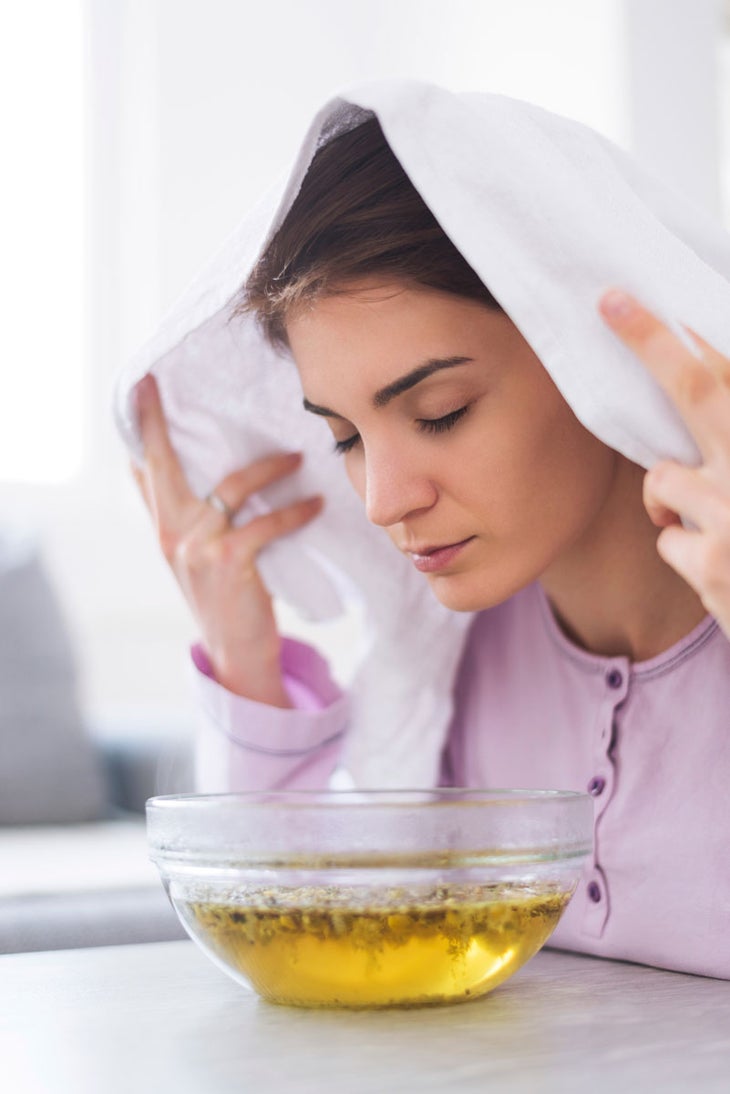 steaming-cold When full blown cold and flu systems occur, ease symptoms of nasal congestion and/or sinus congestion by adding chamomile flowers or 5–10 drops of eucalyptus essential oil (or both!) to boiling water, place your head under a towel over a pot of boiling water—keep a safe distance—and inhale the steaming vapors for 10–15 minutes.